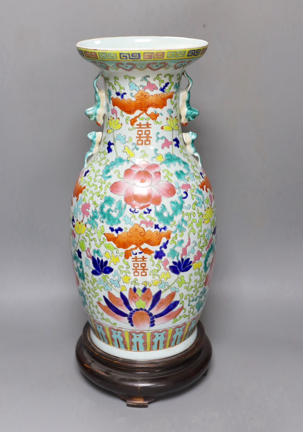 A large Chinese enamelled porcelain vase, on wood stand 53cm